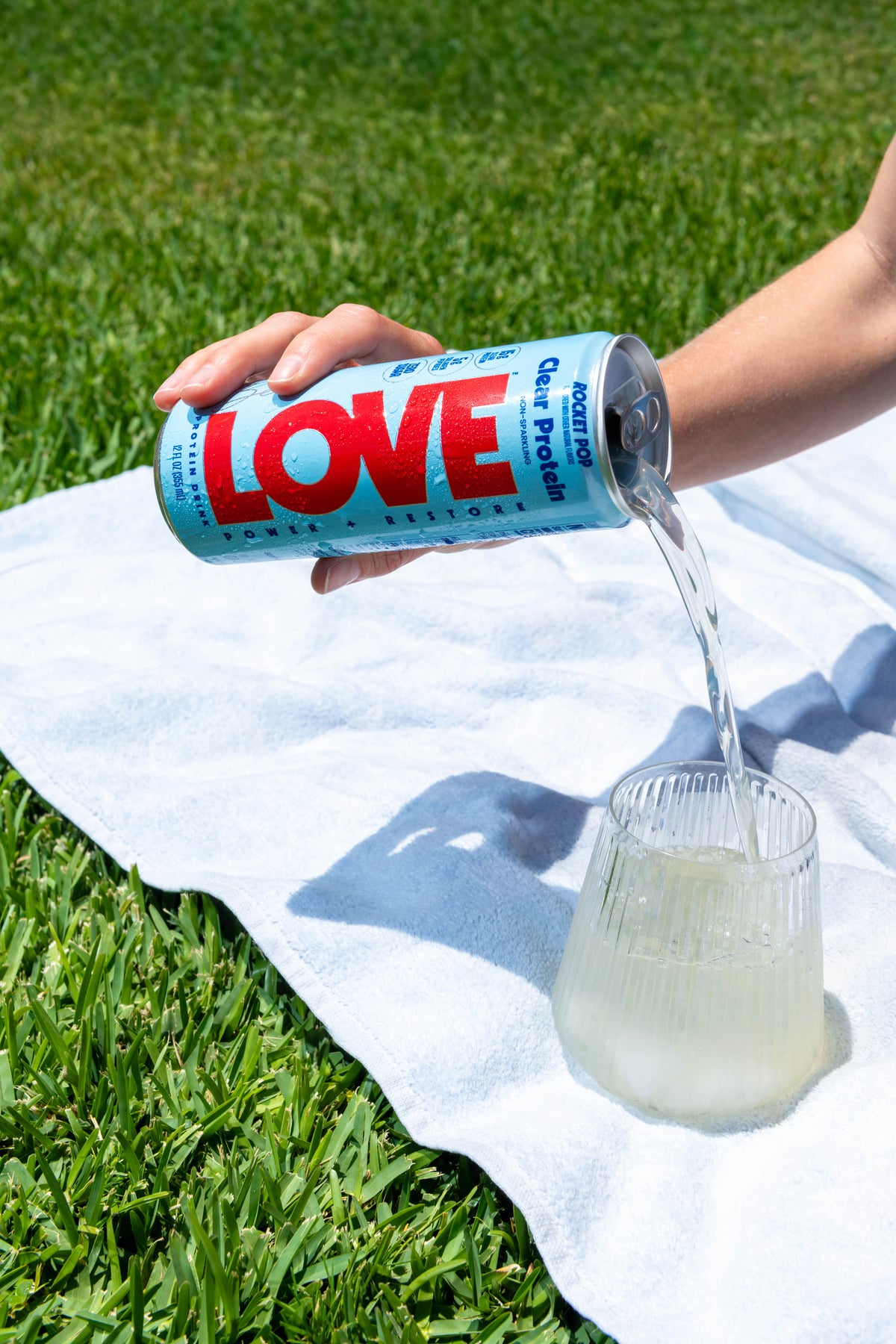 Rocket Pop LOVE clear protein poured into a glass